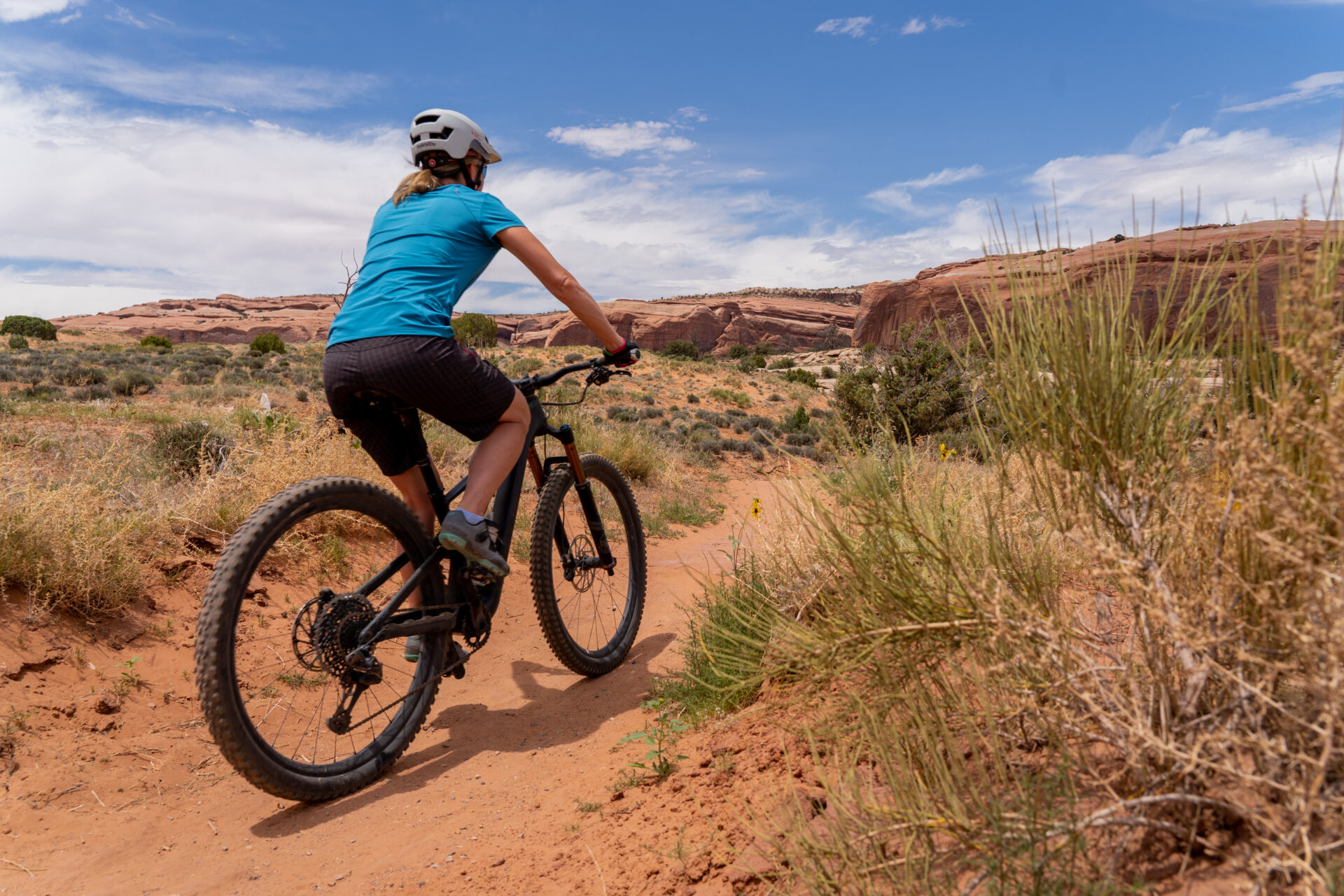 Woman mountain biking in Moab, UT