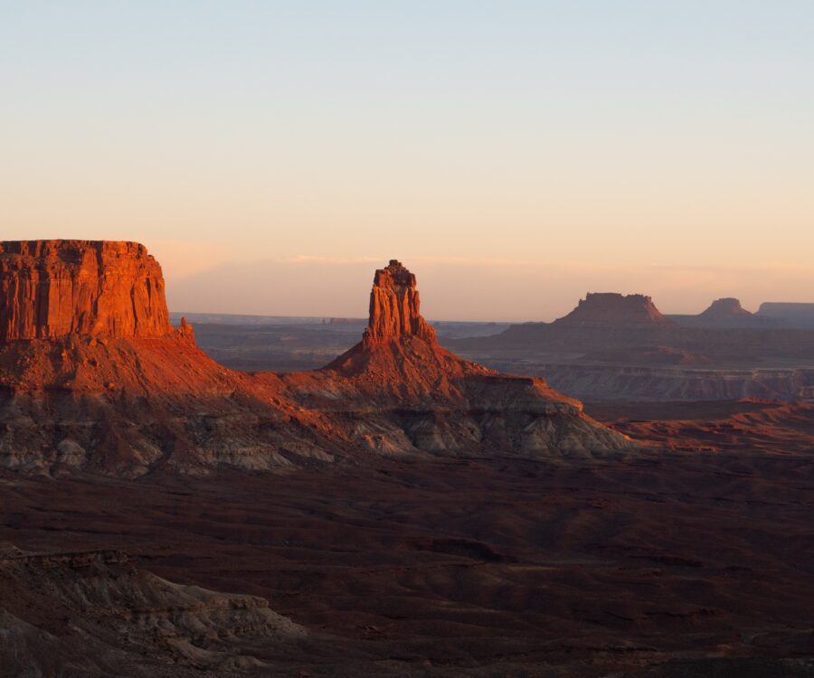 View of the sun setting over red rock in Canyonlands National Park